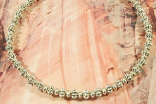 Stunning Necklace Created by the Indian Arts and Crafts Association 2009 Artist of the Year, Alfred Joe. Master Jeweler Alfred Joe created this beautiful necklace with smooth saucer beads interspersed with elegant fluted beads, hand-textured with sand.  A true work of art.